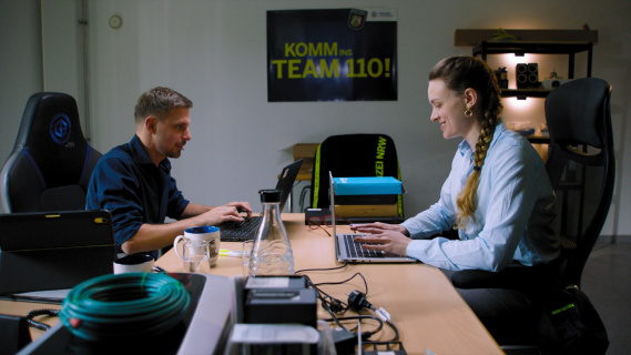 A man and a woman working on Laptops.